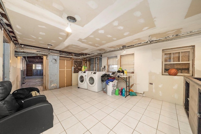 laundry area featuring separate washer and dryer and light tile patterned flooring