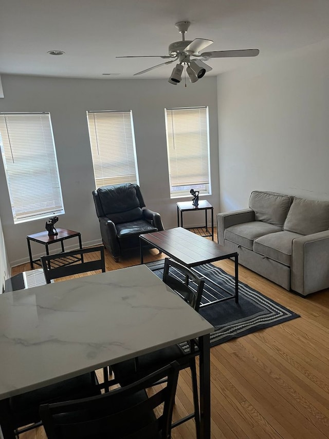 living room featuring light wood-type flooring and ceiling fan