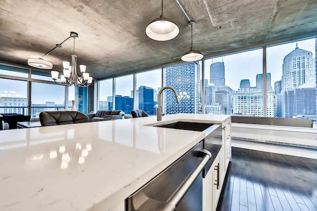 611 S Wells St Unit 1903, Chicago, IL 60607 - kitchen featuring a view of skyline, open floor plan, stainless steel dishwasher, a chandelier, and white cabinetry