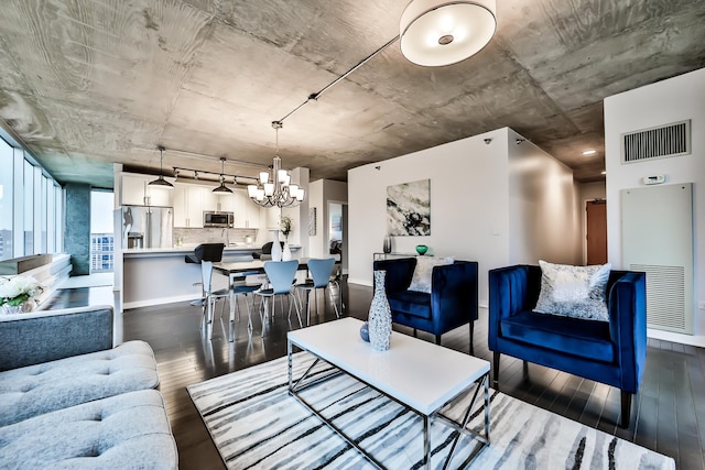 611 S Wells St Unit 1903, Chicago, IL 60607 - living room featuring a heating unit, dark wood finished floors, and a chandelier