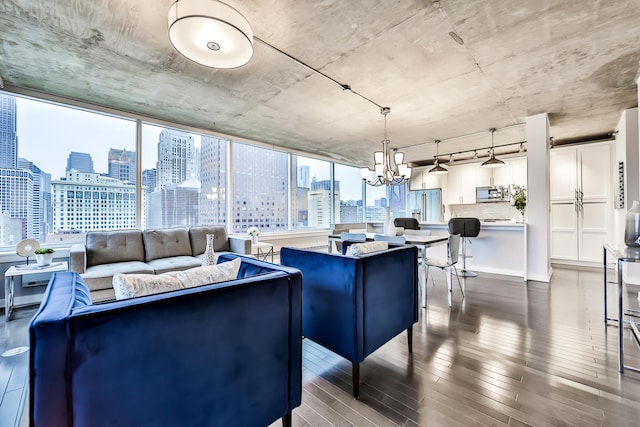 611 S Wells St Unit 1903, Chicago, IL 60607 - living area with a view of skyline, a chandelier, wood finished floors, and plenty of natural light