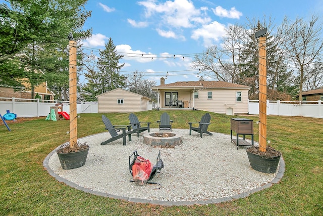 view of yard with an outdoor fire pit, a playground, and a patio area