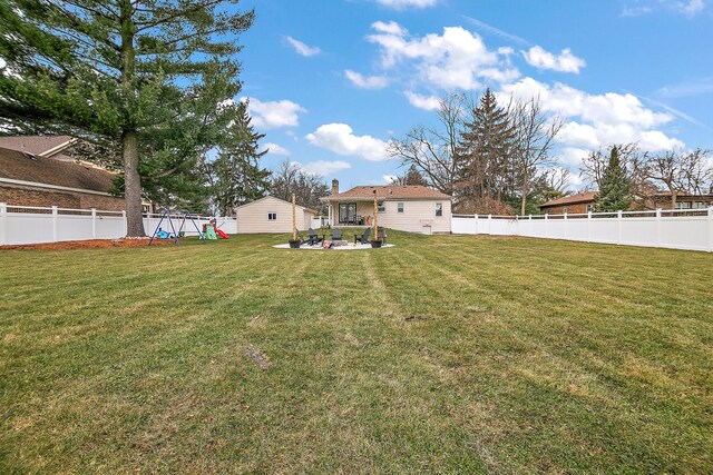 view of yard with a playground and an outdoor fire pit