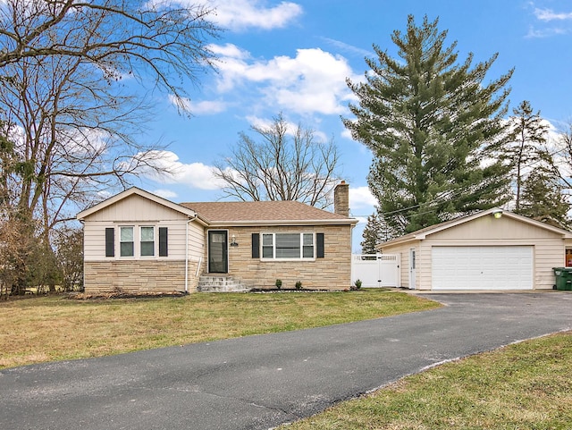 view of front of property with a garage and a front lawn