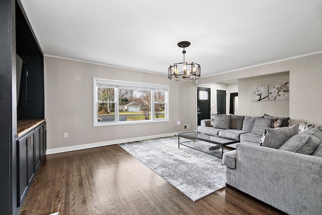 living room with ornamental molding, dark hardwood / wood-style flooring, and a chandelier