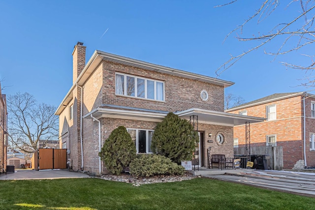 rear view of property featuring a patio area and a yard