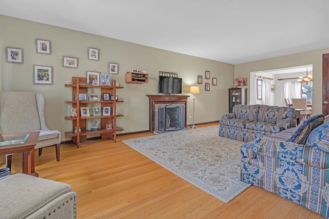 living room with an inviting chandelier and hardwood / wood-style flooring