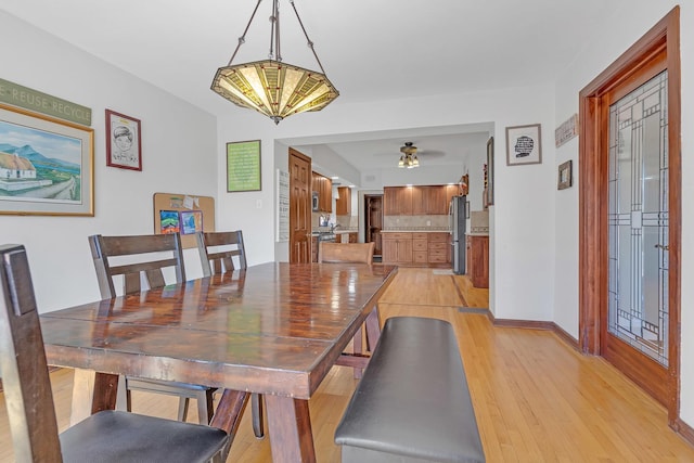 dining room featuring ceiling fan and light hardwood / wood-style flooring