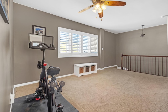 exercise area featuring carpet floors and ceiling fan