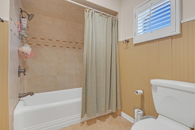 bathroom featuring toilet, shower / tub combo, tile patterned floors, and wood walls