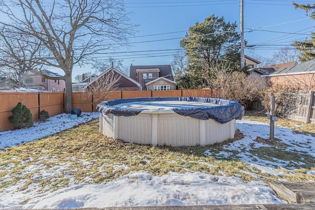 yard covered in snow featuring a covered pool