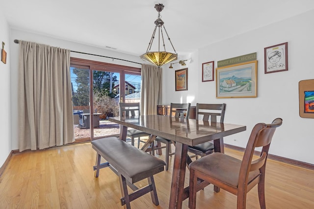 dining area featuring light wood-type flooring