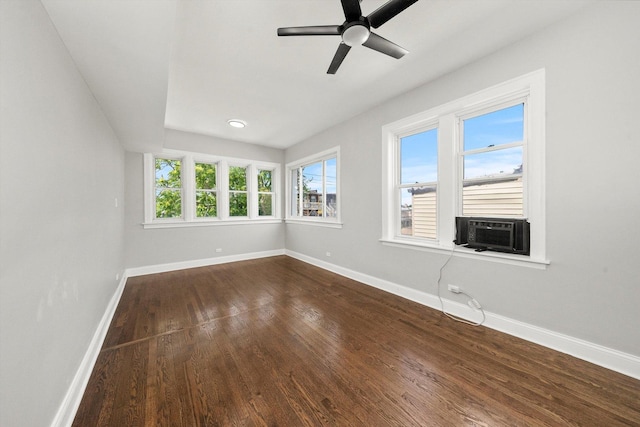 empty room featuring hardwood / wood-style floors, cooling unit, and ceiling fan