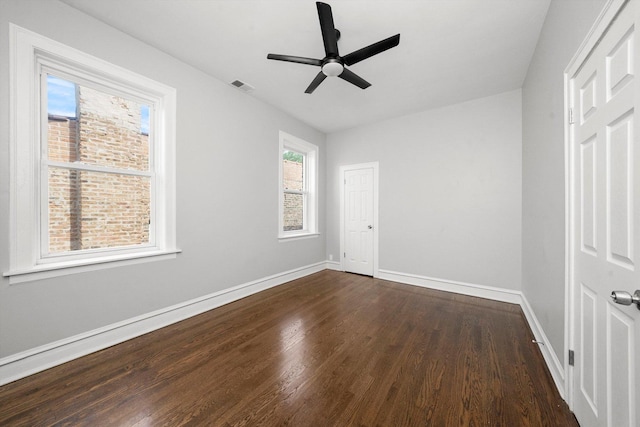 unfurnished bedroom with ceiling fan and dark hardwood / wood-style floors