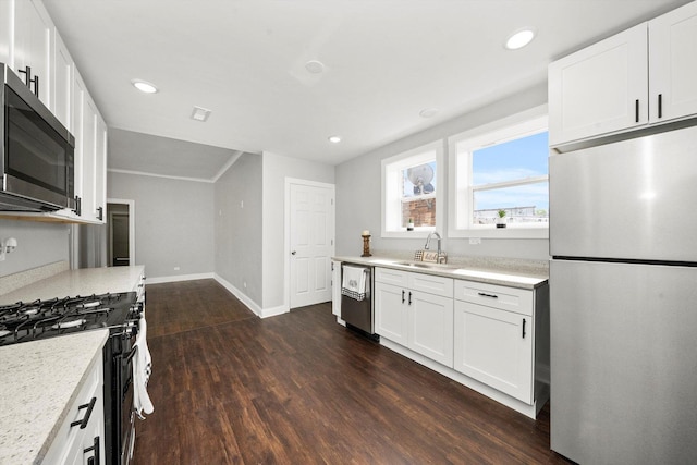 kitchen with white cabinets, stainless steel appliances, dark hardwood / wood-style floors, and sink