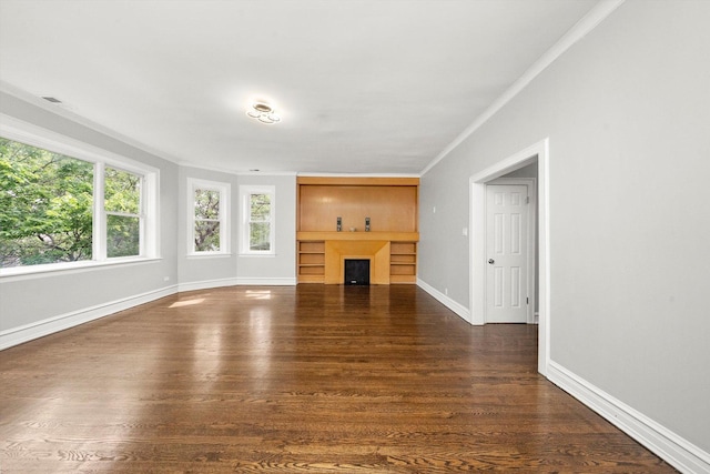 unfurnished living room with crown molding and dark hardwood / wood-style flooring