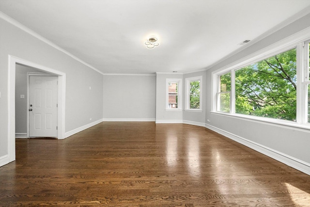 empty room featuring crown molding and dark hardwood / wood-style floors