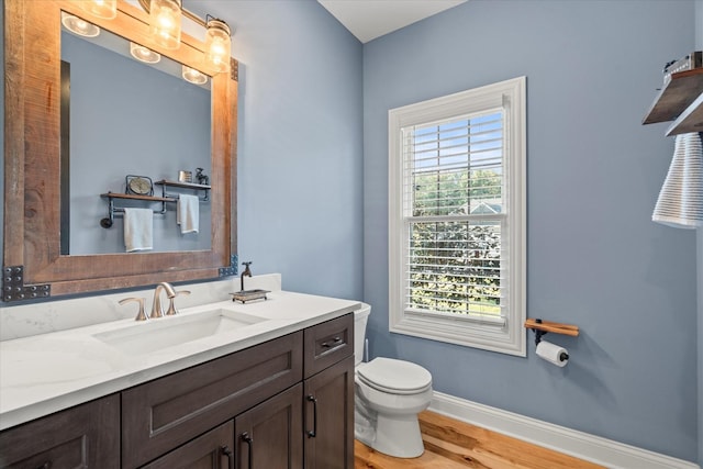 bathroom featuring hardwood / wood-style flooring, vanity, and toilet