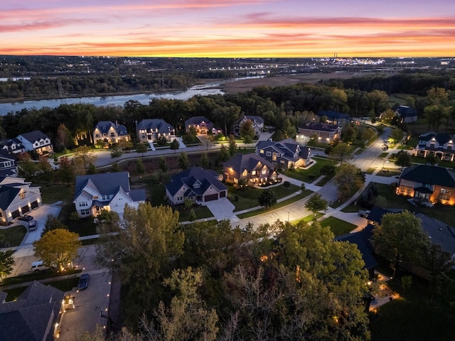 aerial view at dusk with a water view