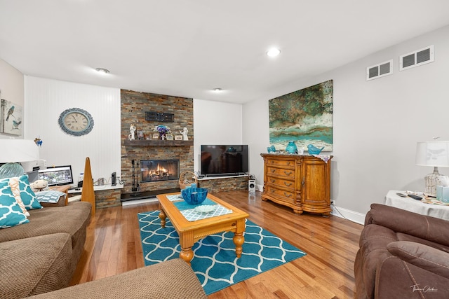 living room featuring a fireplace and wood-type flooring