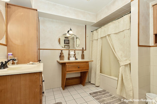 bathroom with tile walls, vanity, tile patterned floors, and shower / bath combo