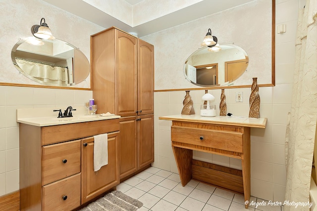 bathroom featuring tile patterned floors, vanity, and tile walls