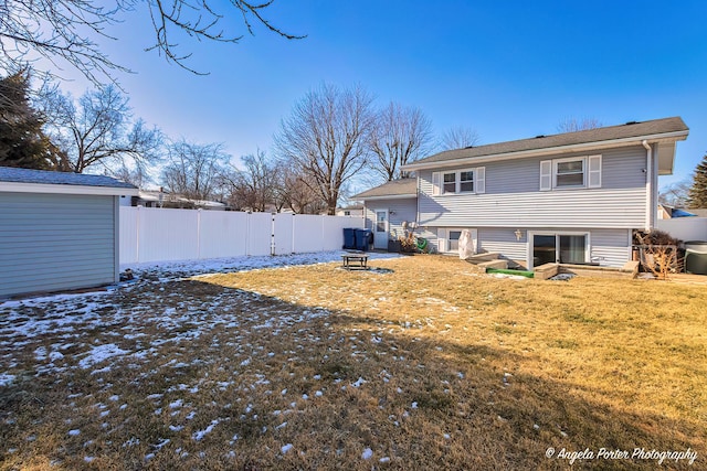 back of property featuring a lawn and a fire pit