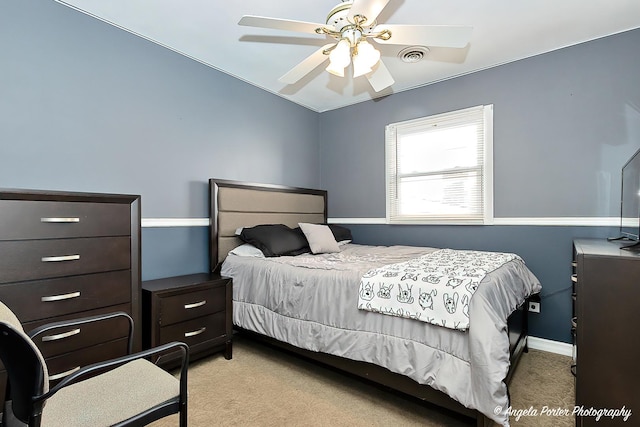 bedroom with ceiling fan and light colored carpet