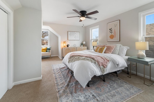 bedroom featuring multiple windows, carpet flooring, and ceiling fan