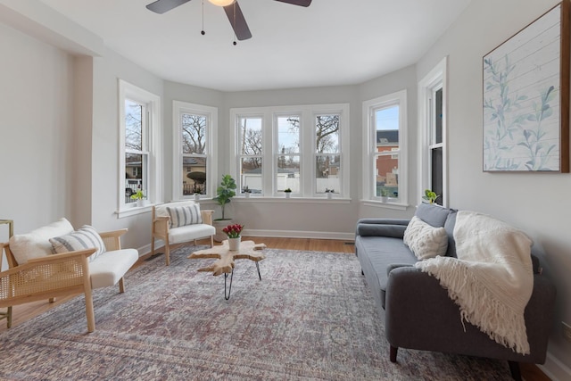 sunroom / solarium featuring ceiling fan