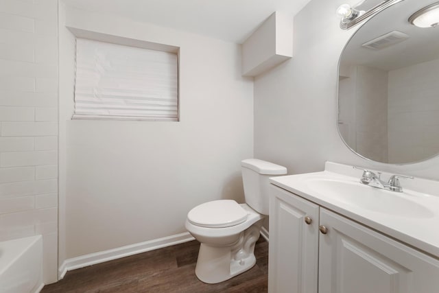 bathroom featuring vanity, hardwood / wood-style flooring, and toilet