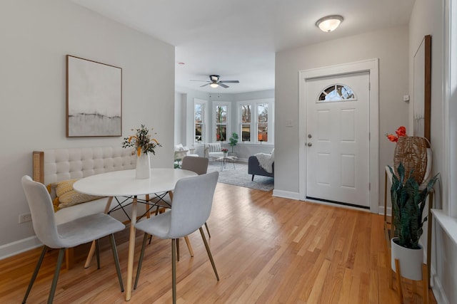 dining area with ceiling fan, breakfast area, and light wood-type flooring