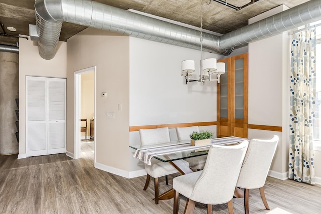 dining space with hardwood / wood-style flooring