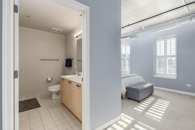 bathroom featuring toilet, vanity, and tile patterned flooring