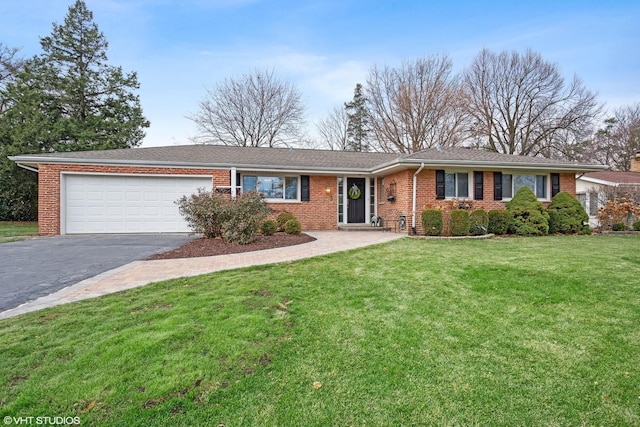 ranch-style house featuring a garage and a front lawn