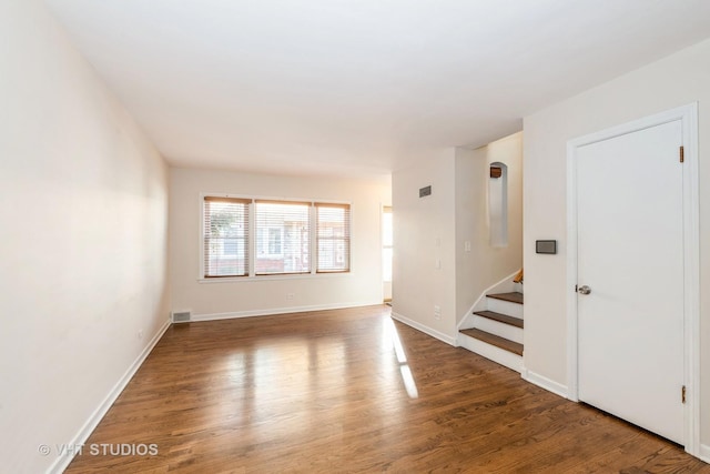 empty room featuring dark hardwood / wood-style flooring