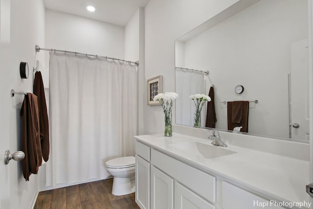 bathroom featuring hardwood / wood-style floors, vanity, and toilet