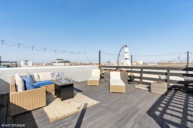 wooden deck featuring an outdoor living space with a fire pit