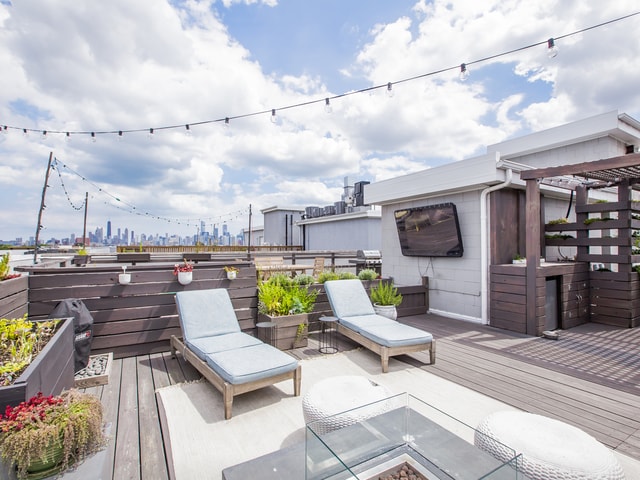 wooden terrace with a grill