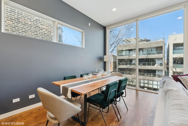 dining area with hardwood / wood-style floors and expansive windows