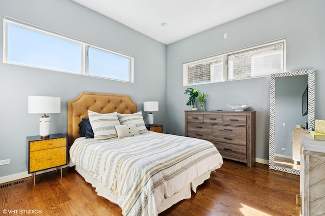 bedroom with dark hardwood / wood-style flooring