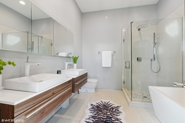 bathroom with tile patterned flooring, vanity, toilet, and a shower with shower door