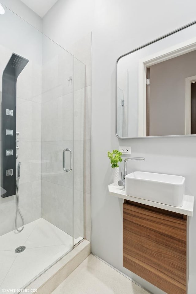 bathroom featuring vanity and a shower with door