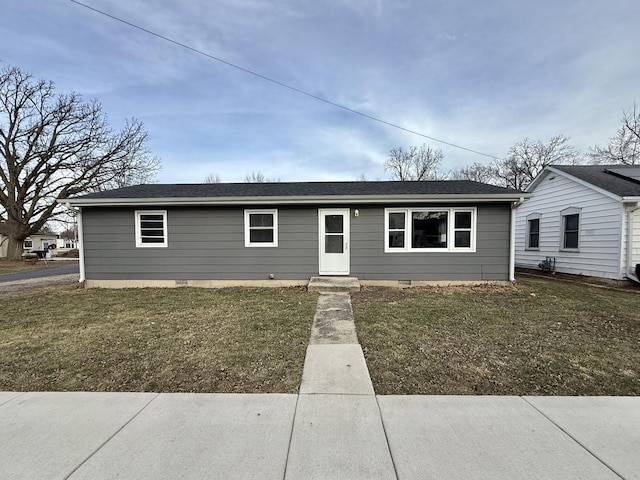 single story home featuring a front lawn