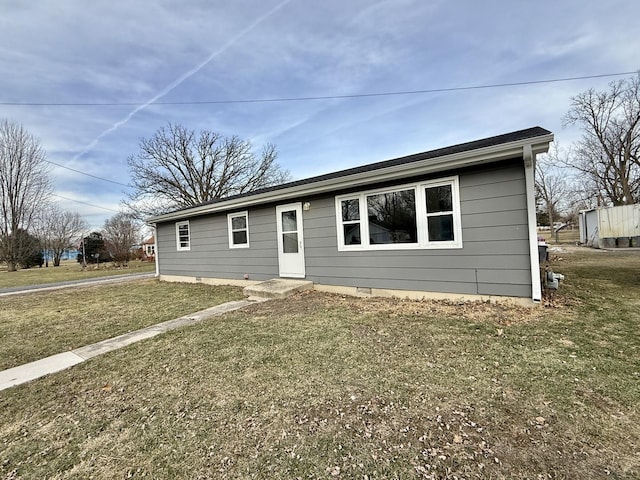 ranch-style home with a front lawn