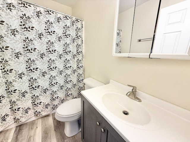 bathroom featuring hardwood / wood-style floors, vanity, and toilet