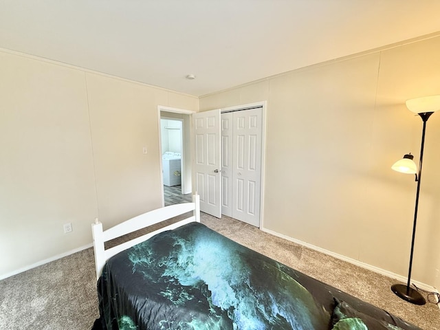 carpeted bedroom featuring washer / clothes dryer