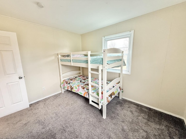 bedroom with dark colored carpet