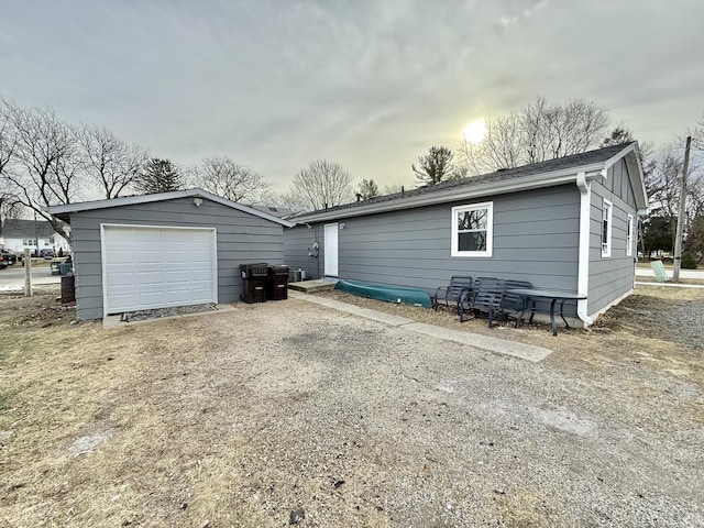 rear view of property with a garage