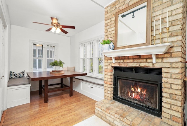 interior space with hardwood / wood-style floors, a fireplace, and ceiling fan